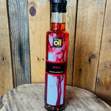 Bottle of chili oil on a wooden surface with a wooden background