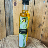 Bottle of Rosemary & Garlic infused rapeseed oil on a wooden surface