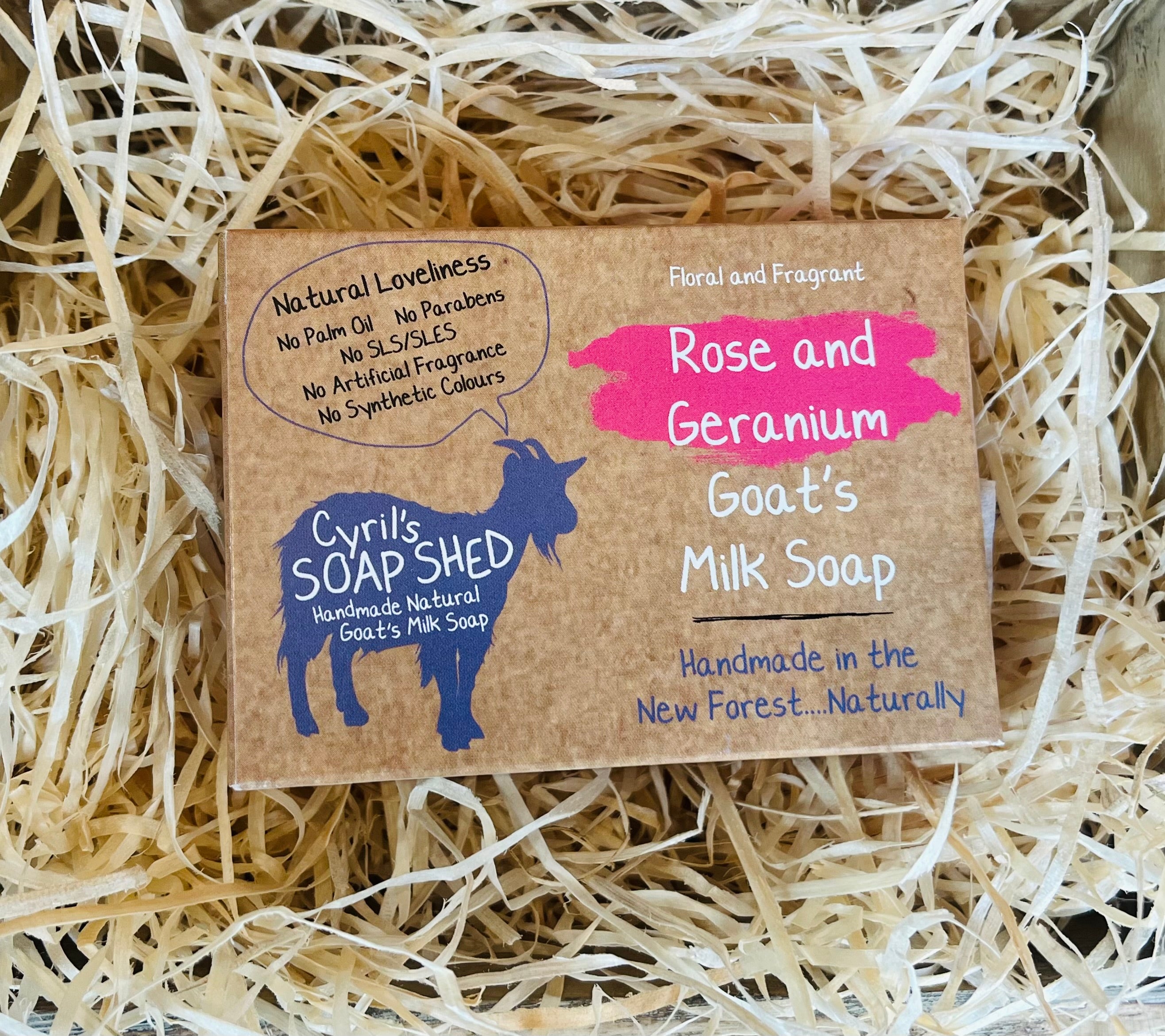 Goat's milk soap packaging with branding on a bed of straw
