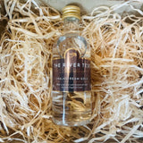 Bottle of The River Test Distillery Chalkstream Gold gin on a bed of straw