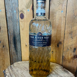 Bottle of The River Test Distillery Chalkstream Gold on a wooden surface