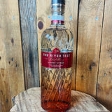 Bottle of 'The River Test Distillery Sunset Citrus' on a wooden barrel with a wooden background