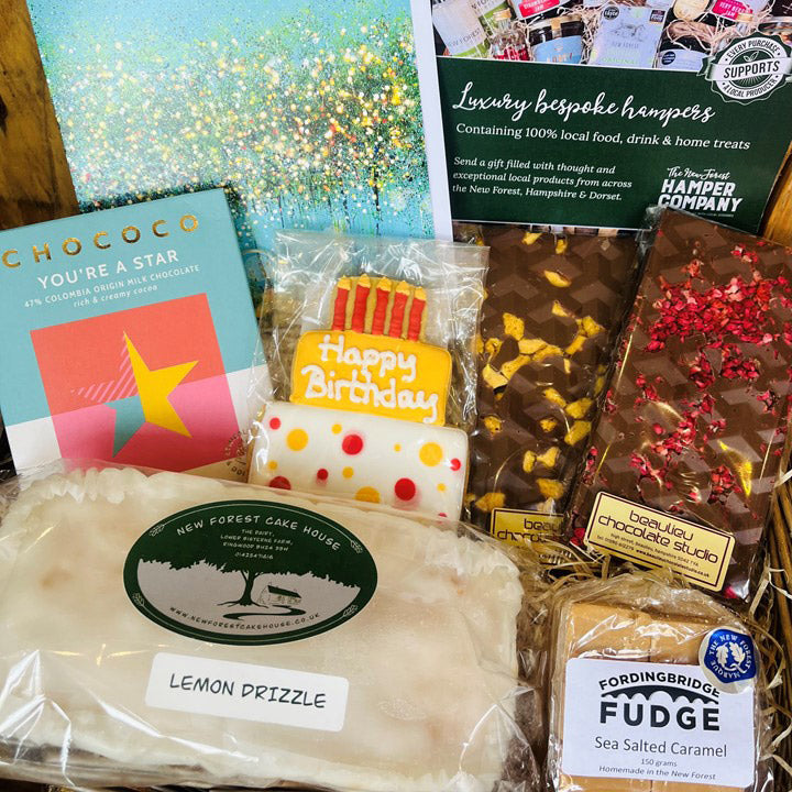 Assorted gift items including cake, chocolate, and fudge with visible branding.