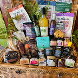 Close view of The Ultimate Hampshire & Dorset Goodies Hamper showing red onion marmalade, Sway Chutney, fig and olive chutney, Herbes de Provence olives, oak-smoked tomato balsamic and New Forest wildflower honey