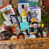 Close view of the Ultimate Christmas Goodies Hamper showing Christmas chutney, three fruit marmalade, Very Berry Christmas jam, Sway Chutney, tomato and chilli jam and New Forest wildflower honey