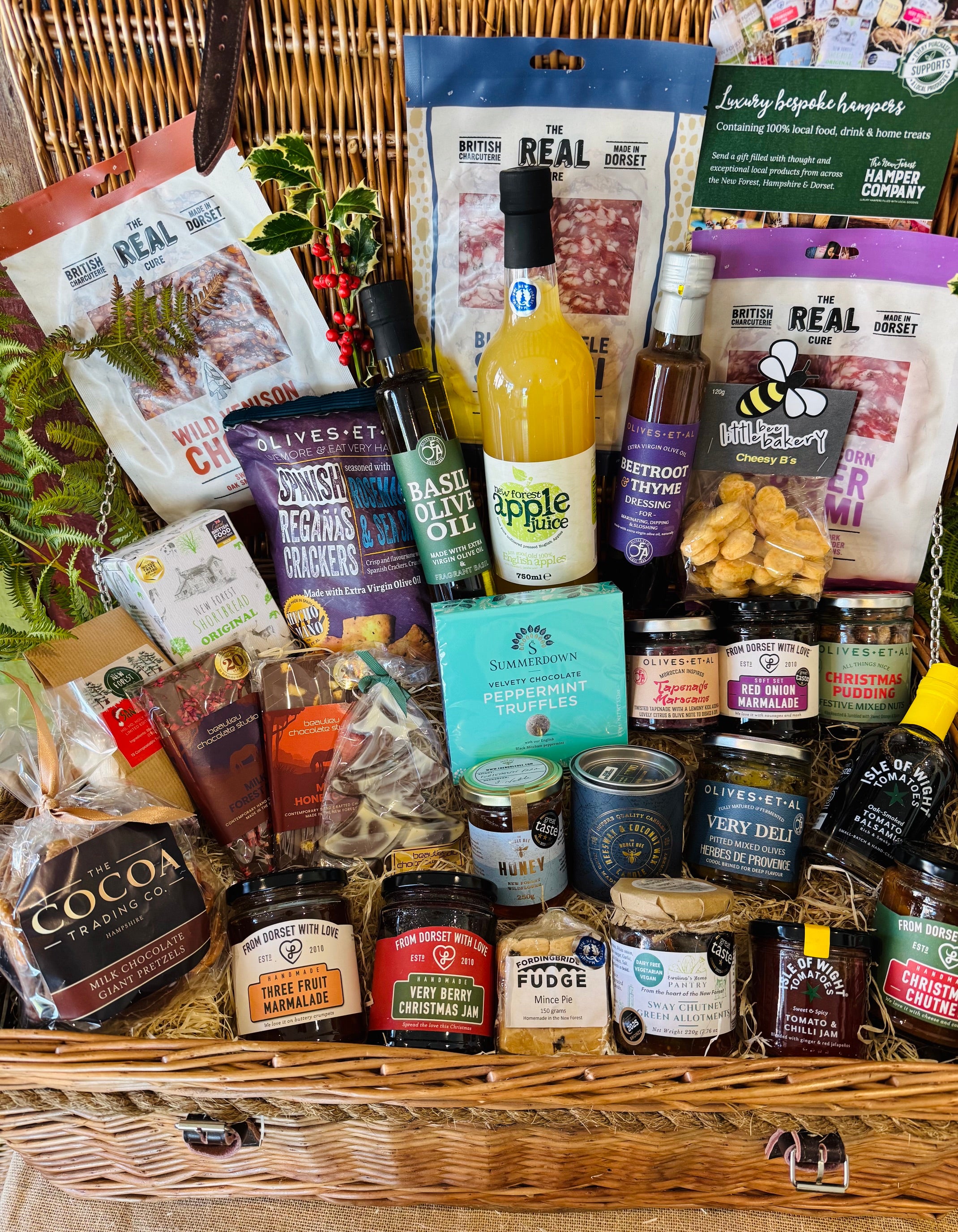 The Ultimate Christmas Goodies Hamper from above - thirty festive items including Beaulieu chocolate Christmas trees, Summerdown peppermint truffles, Christmas pudding festive nuts and New Forest Shortbread in a 24 inch willow basket