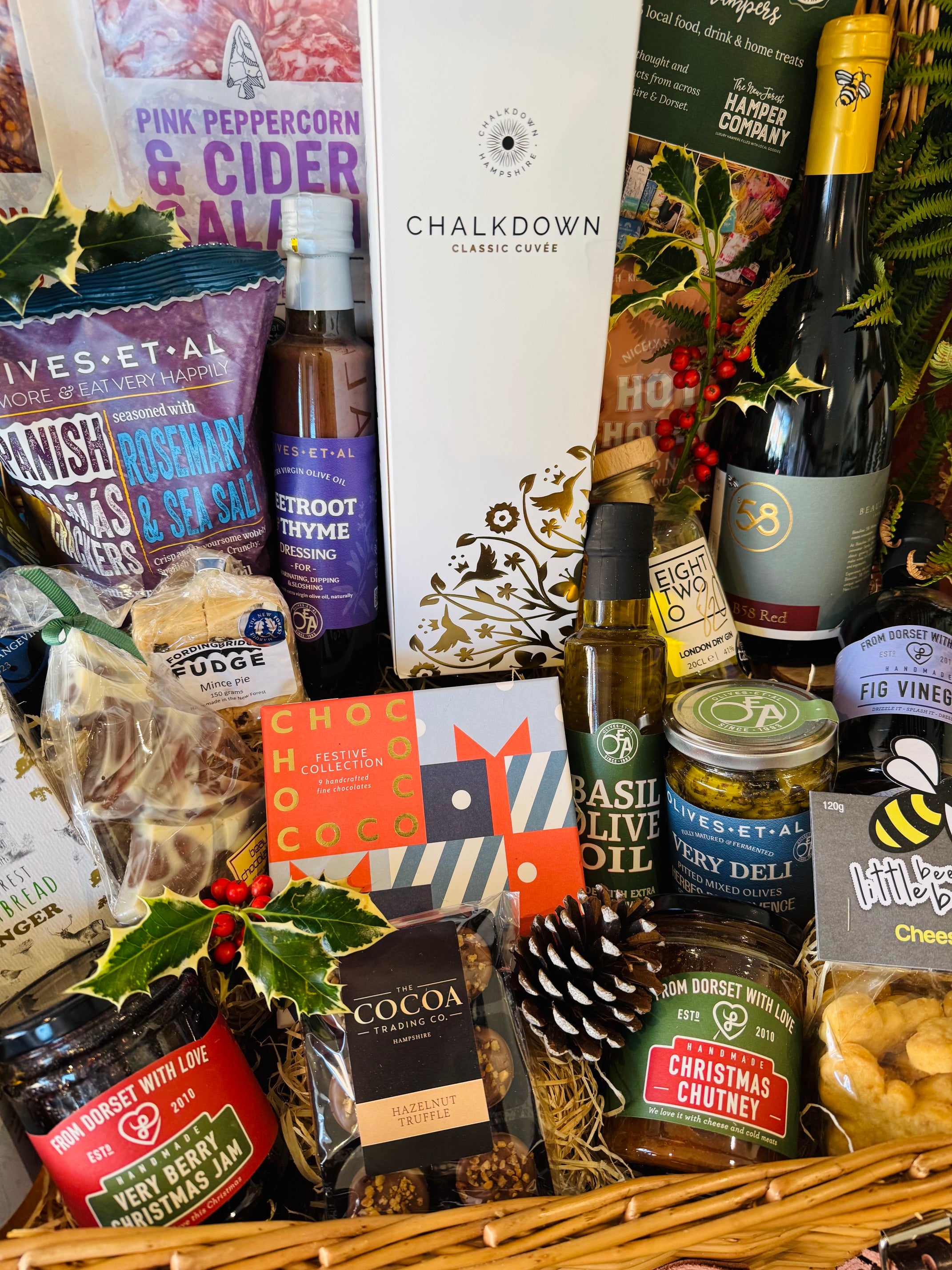 Dorset charcuterie, Spanish Reganas crackers and Olives et Al olives in a festive New Forest willow hamper