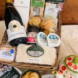 Chalkdown Afternoon Tea Hamper contents laid out with Chalkdown Classic Cuvée, The Forest Deli fruit scones, Rodda's Cornish clotted cream and New Forest Cake House lemon drizzle