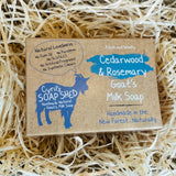 Goat's milk soap bar with Cyril's Soap Shed branding on a bed of straw.