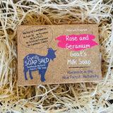 Goat's milk soap packaging with branding on a bed of straw