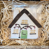 Decorative house ornament in a box with straw-like material