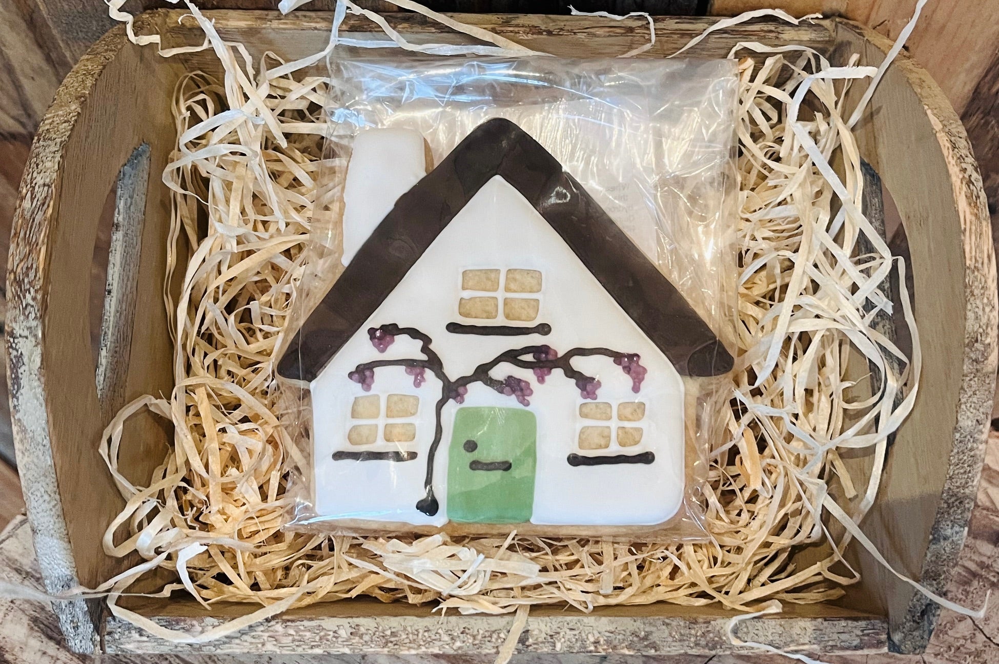 Decorative house ornament in a box with straw-like material