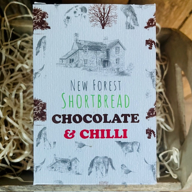 Packaging for New Forest Shortbread with chocolate and chilli flavor, featuring illustrations of a house and trees.