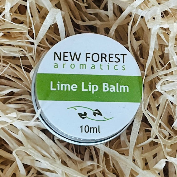 Lime lip balm container labeled 'New Forest Aromatics' on a bed of straw.