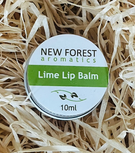 Lime lip balm container labeled 'New Forest Aromatics' on a bed of straw.
