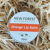 New Forest Aromatics Orange Lip Balm on a bed of straw