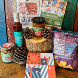 Festive Dorset Giftbox contents styled for Christmas with Chococo festive chocolate collection, Dorset charcuterie and festive chutney