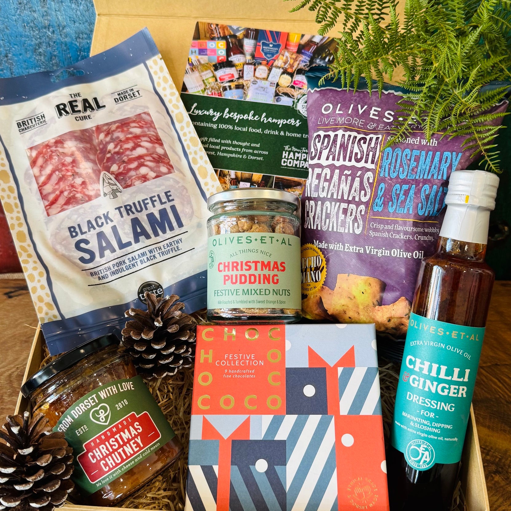 Festive Dorset Giftbox filled with Chococo festive chocolates, Real Cure black truffle salami, Christmas pudding mixed nuts, Christmas chutney and Reganas crackers