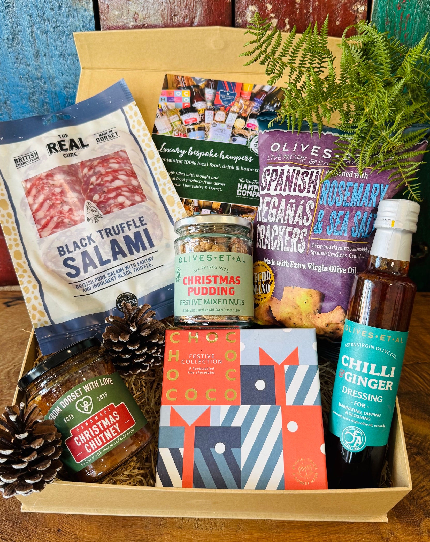 Festive Dorset Giftbox filled with Chococo festive chocolates, Real Cure black truffle salami, Christmas pudding mixed nuts, Christmas chutney and Reganas crackers