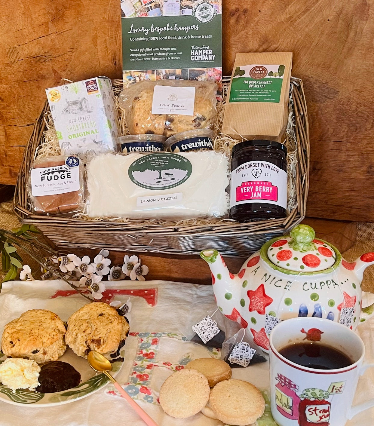 New Forest hamper company Afternoon tea hamper with fruit scones, clotted cream, lemon drizzle cake, shortbread, jam and New Forest Breakfast Tea, styled with teapot and cup