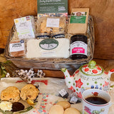 New Forest hamper company Afternoon tea hamper with fruit scones, clotted cream, lemon drizzle cake, shortbread, jam and New Forest Breakfast Tea, styled with teapot and cup