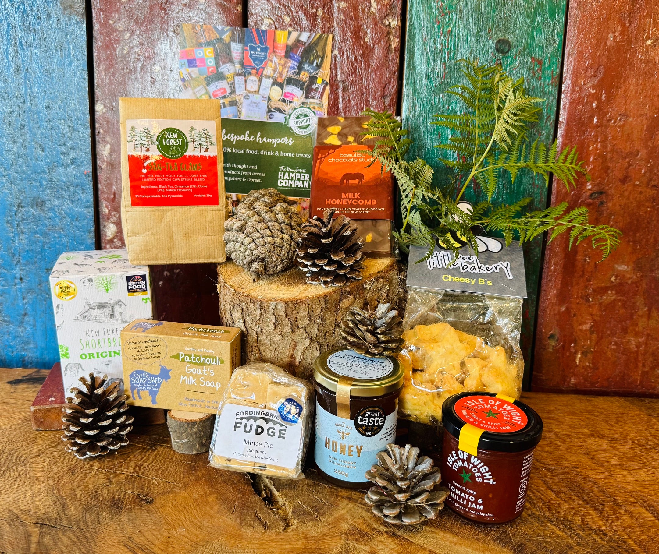 Festive Hampshire Giftbox styled with pine cones, San-Tea Claus Christmas tea, Little Bee Bakery cheesy stars and New Forest Shortbread Original