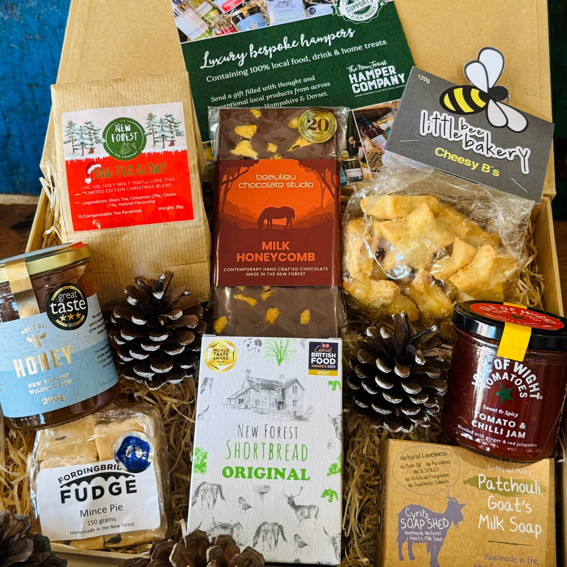 Festive Hampshire Giftbox packed with San-Tea Claus Christmas tea, New Forest wildflower honey, mince pie fudge, Original shortbread, Beaulieu milk honeycomb chocolate, cheesy stars, tomato chilli jam and patchouli goat's milk soap