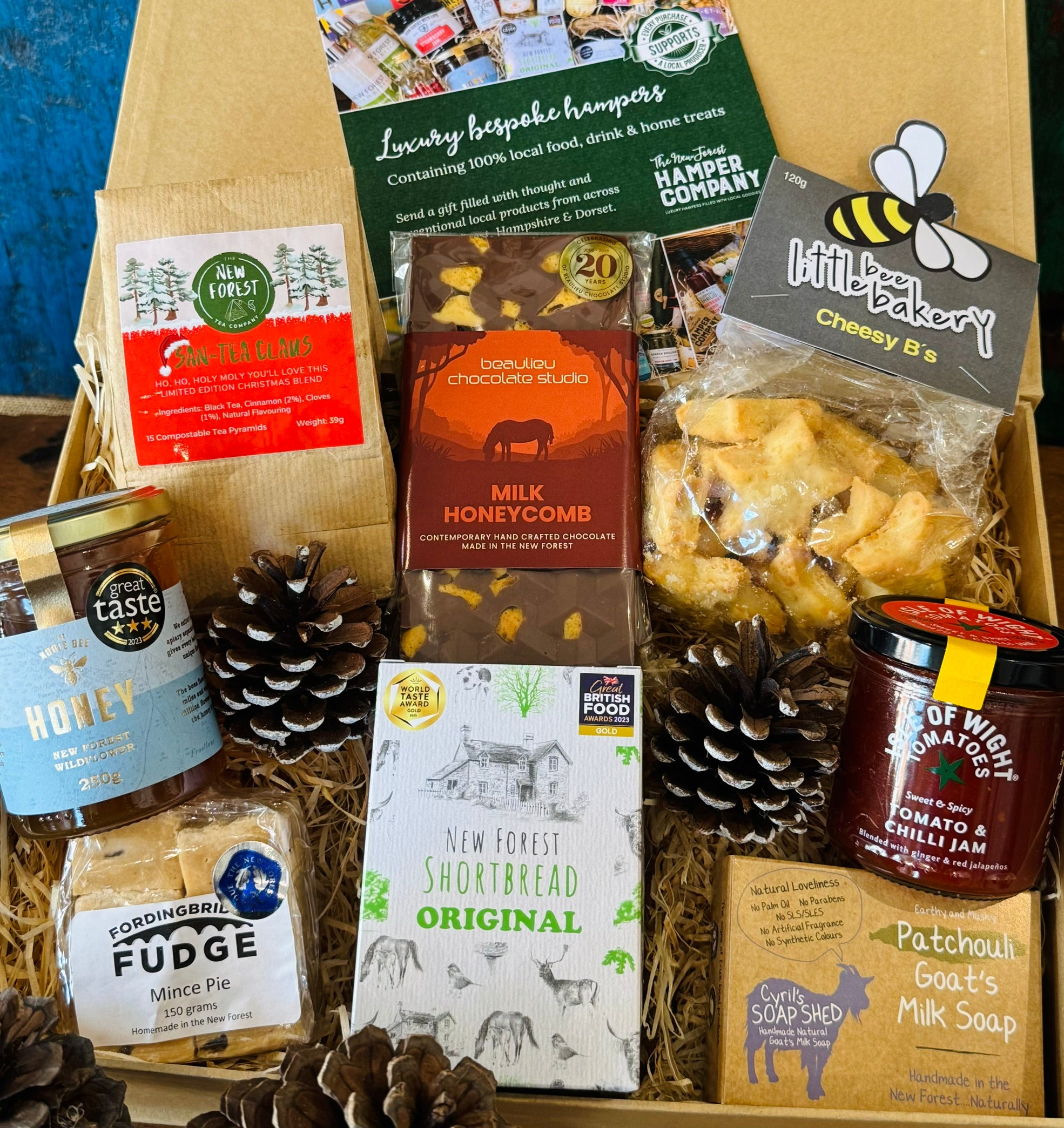 Festive Hampshire Giftbox packed with San-Tea Claus Christmas tea, New Forest wildflower honey, mince pie fudge, Original shortbread, Beaulieu milk honeycomb chocolate, cheesy stars, tomato chilli jam and patchouli goat's milk soap