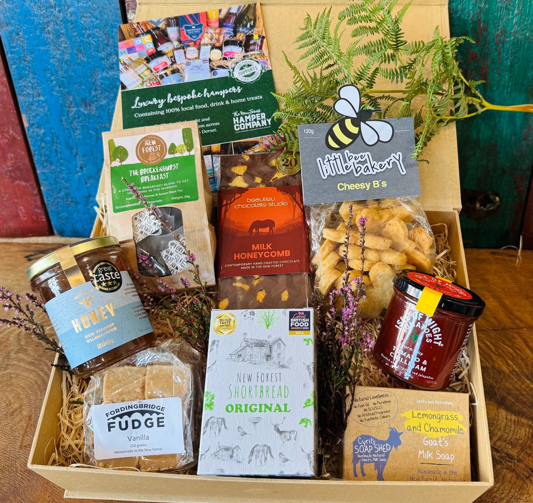 Hampshire Giftbox contents displayed with Noble Bee honey, New Forest Tea Company Brockenhurst Breakfast, gold award-winning New Forest Shortbread and Cyril's Soap Shed goat's milk soap