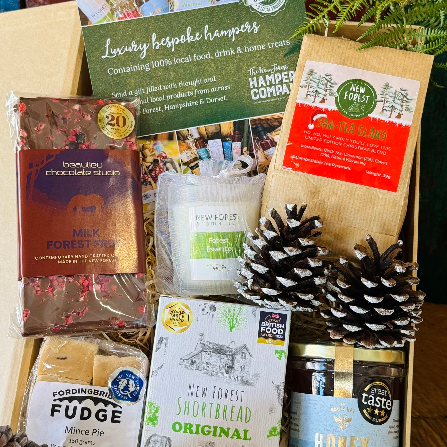 New Forest Marque Festive Giftbox packed with San-Tea Claus Christmas tea, Noble Bee wildflower honey, Original shortbread, Beaulieu Forest Fruit chocolate, mince pie fudge and a Forest Essence candle