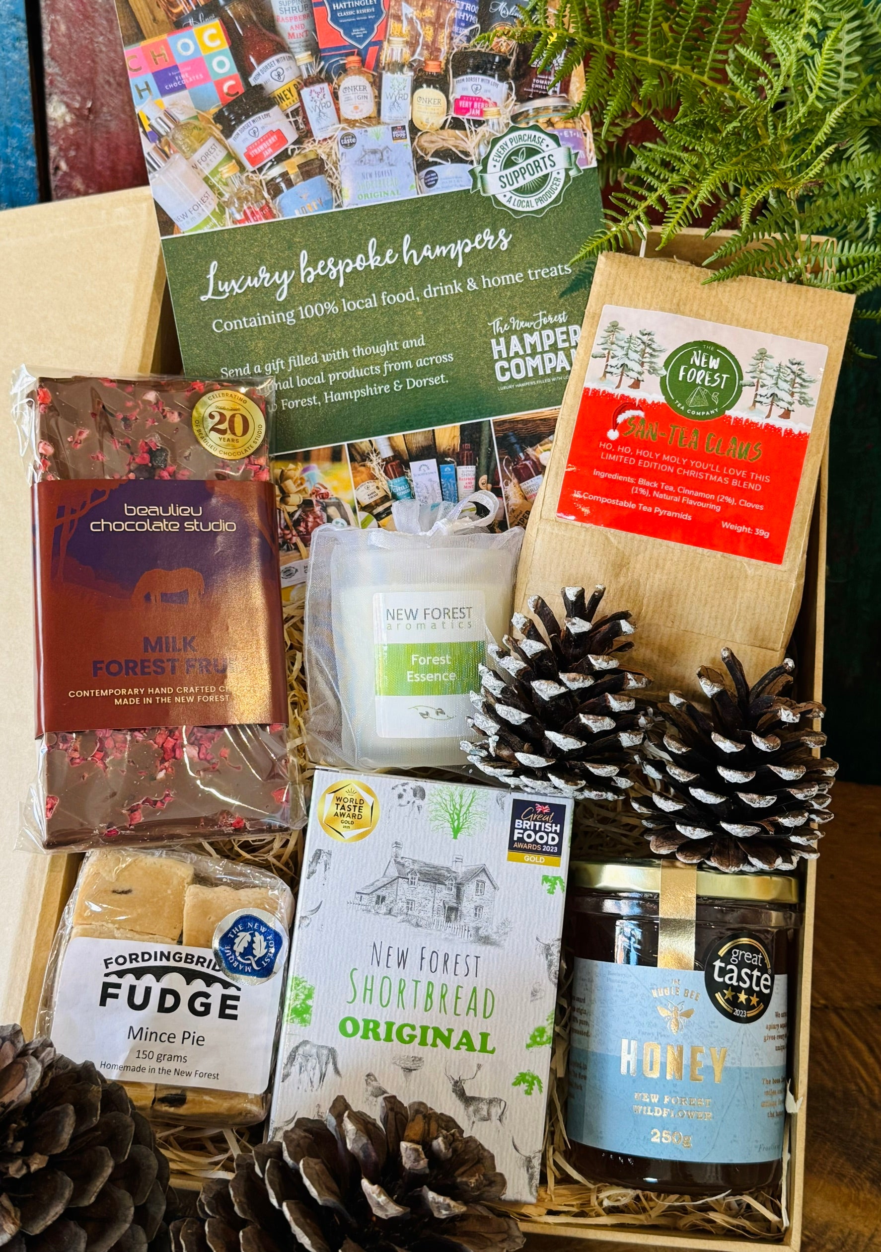 New Forest Marque Festive Giftbox packed with San-Tea Claus Christmas tea, Noble Bee wildflower honey, Original shortbread, Beaulieu Forest Fruit chocolate, mince pie fudge and a Forest Essence candle