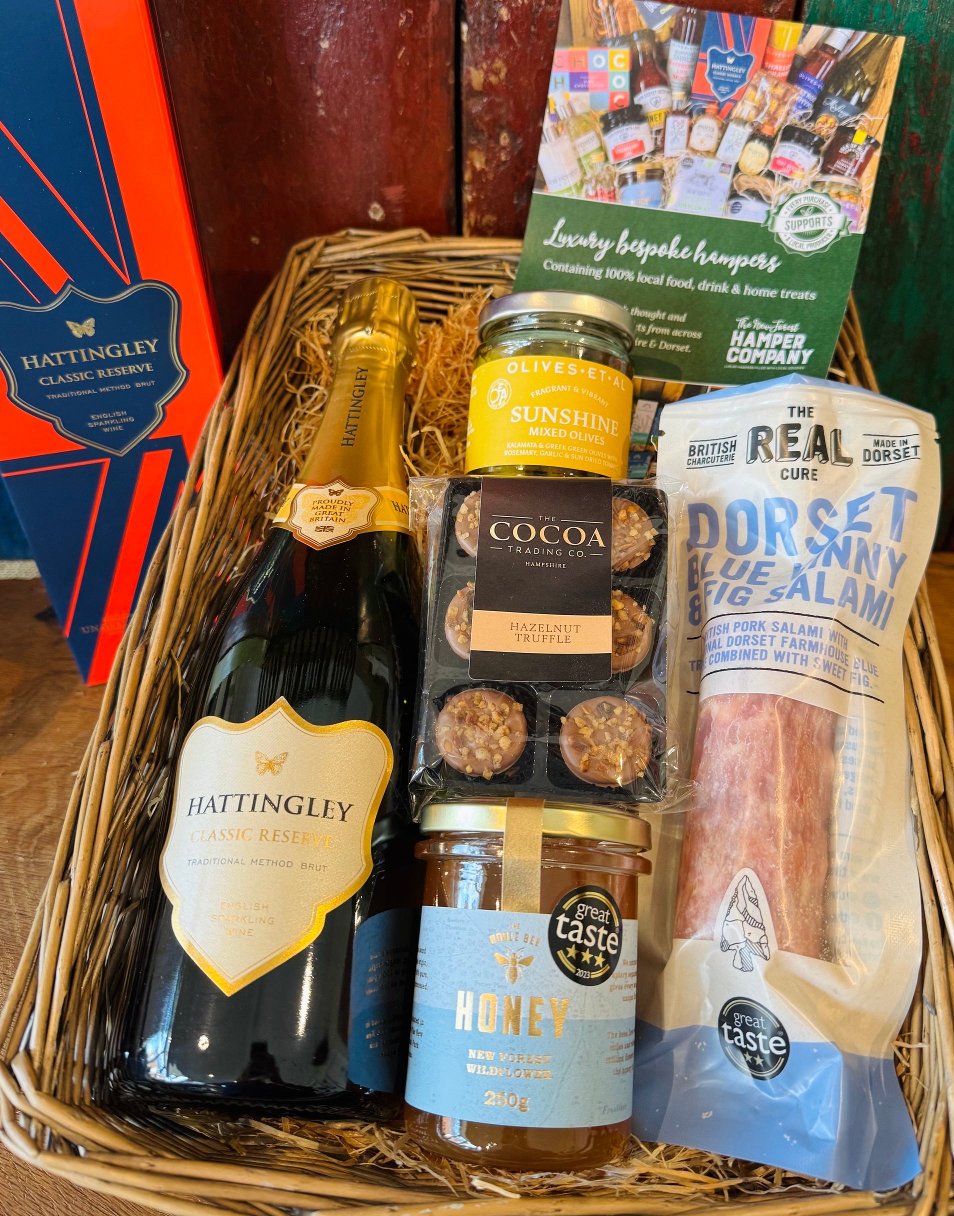 Hattingley Gourmet Grazer basket filled with Hattingley Classic Reserve, Real Cure Blue Vinny & Fig salami, Olives et Al Sunshine olives and Cocoa Trading hazelnut truffles