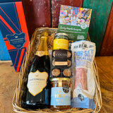 Hattingley Gourmet Grazer hamper basket wrapped and dressed with a raffia bow, ready to give