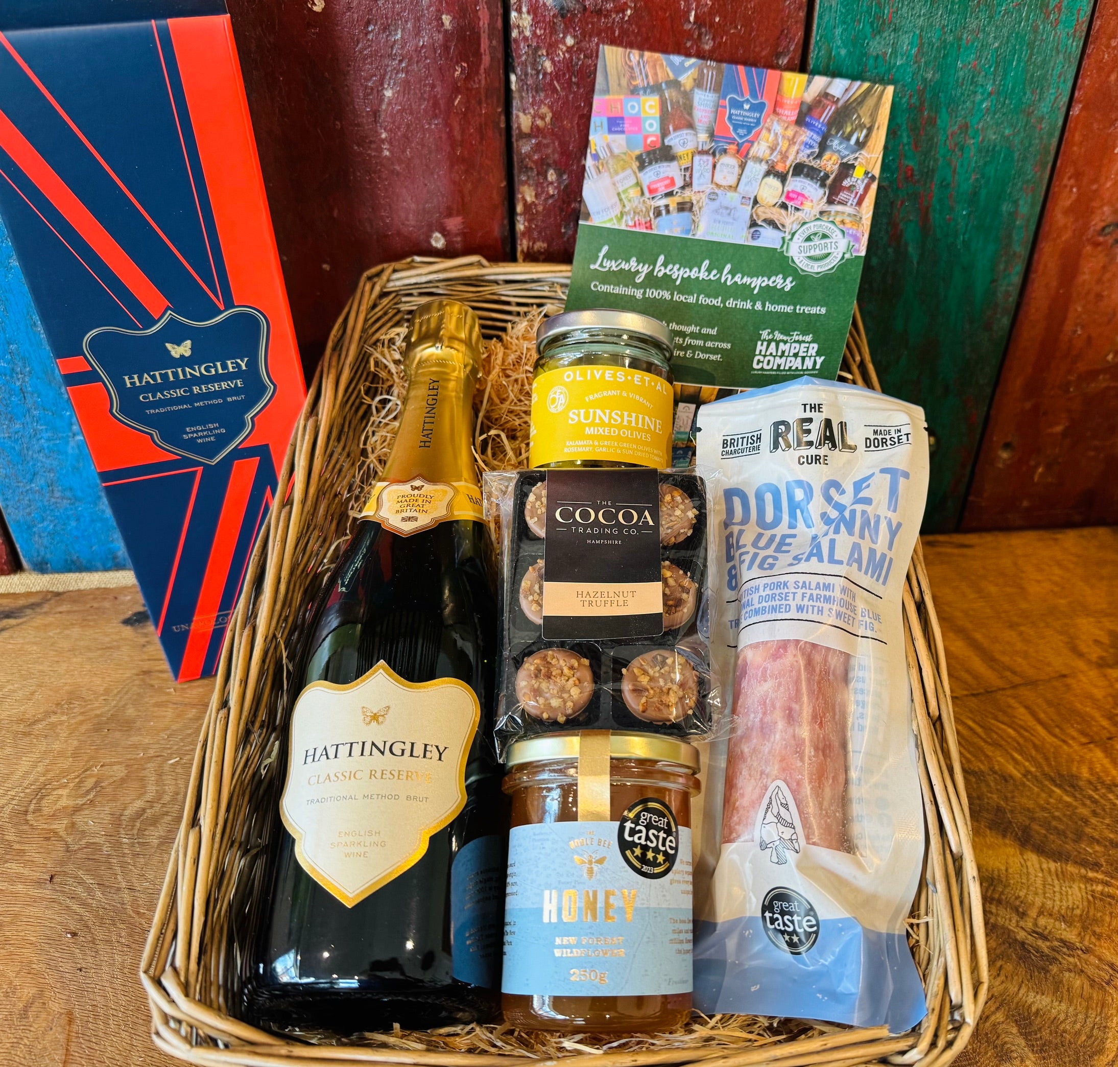 Hattingley Gourmet Grazer hamper basket wrapped and dressed with a raffia bow, ready to give
