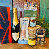 Hattingley Gourmet Grazer contents displayed on wood with English sparkling wine, Dorset Blue Vinny & Fig salami, New Forest wildflower honey and Sunshine mixed olives