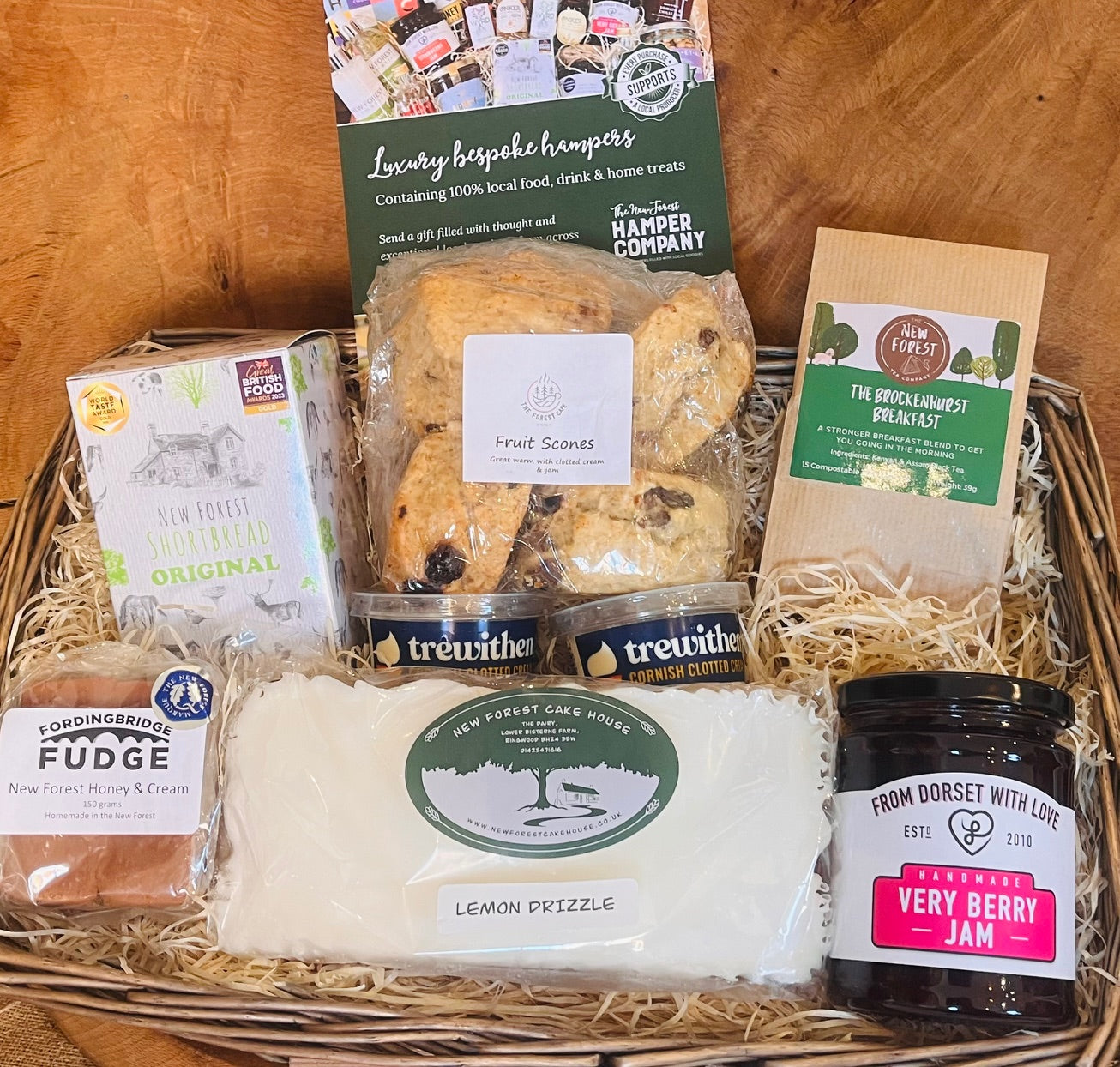 New Forest Hamper company Afternoon Tea Hamper with fruit scones, clotted cream, lemon drizzle cake, shortbread, fudge, jam and breakfast tea in wicker basket