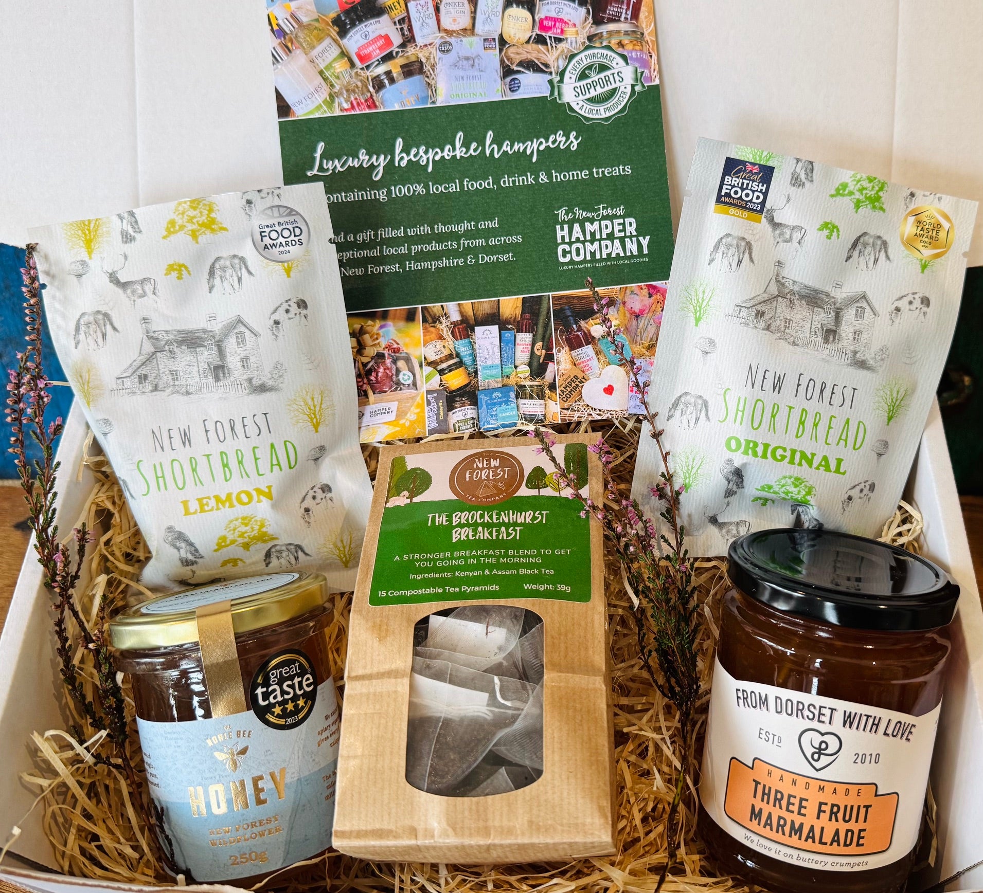 The Brockenhurst Tea & Treats Postal Box with Brockenhurst Breakfast tea, Noble Bee New Forest wildflower honey, From Dorset With Love Three Fruit marmalade and New Forest Shortbread in original and lemon