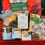 Close-up of the New Forest Festive Favourites Giftbox, showing the Original shortbread, Noble Bee wildflower honey and Fordingbridge mince pie fudge in their red gift box
