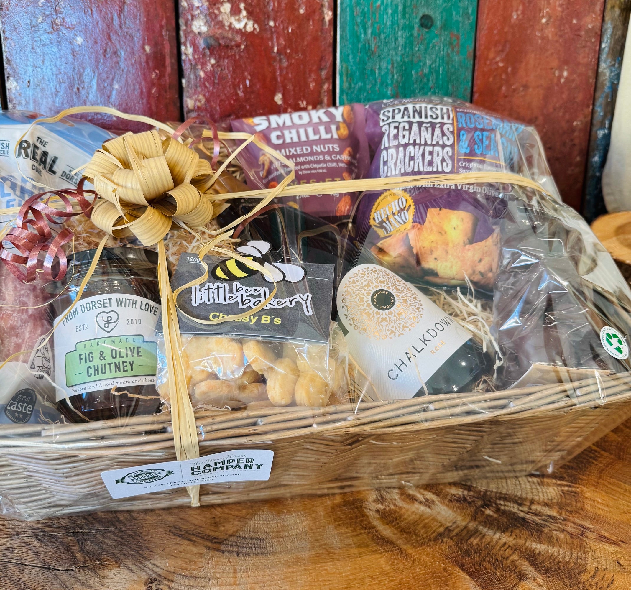 The Perfect Evening In Hamper wrapped in cellophane with a raffia bow, ready to give