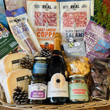 The Perfect Festive Evening In hamper in an extra large antique willow basket with Chalkdown sparkling rose, Dorset charcuterie, Lyburn cheeses, Christmas pudding nuts and dark chocolate honeycomb