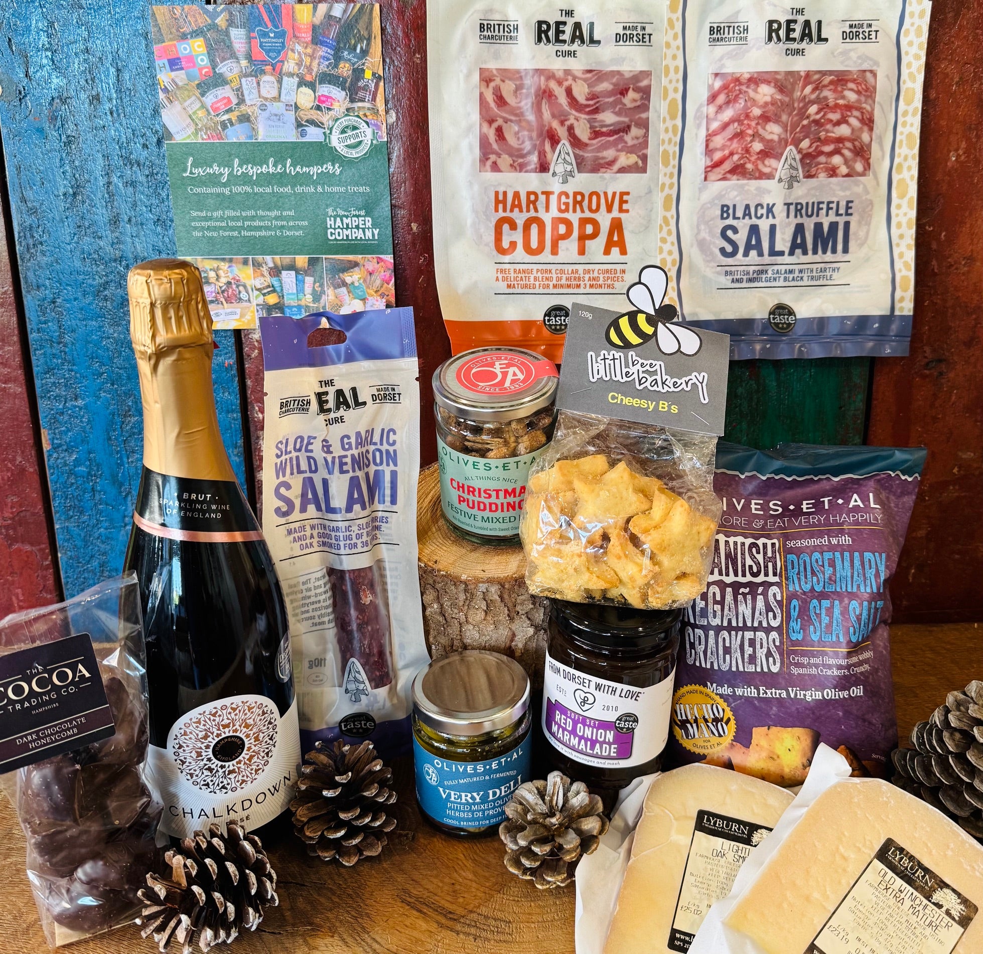 The Perfect Festive Evening In contents laid out with Chalkdown Hampshire sparkling rose, Dorset charcuterie, Reganas crackers, festive mixed nuts and Lyburn farmhouse cheeses