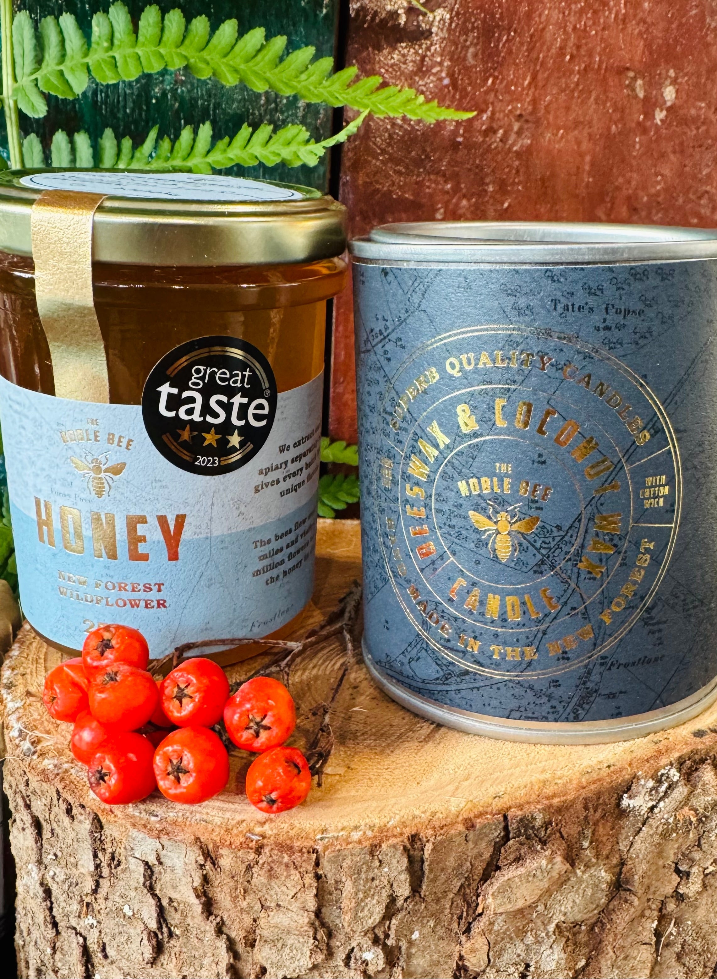 The Noble Bee New Forest wildflower honey with its three star Great Taste award, beside the Noble Bee beeswax and coconut wax candle, both made in the New Forest