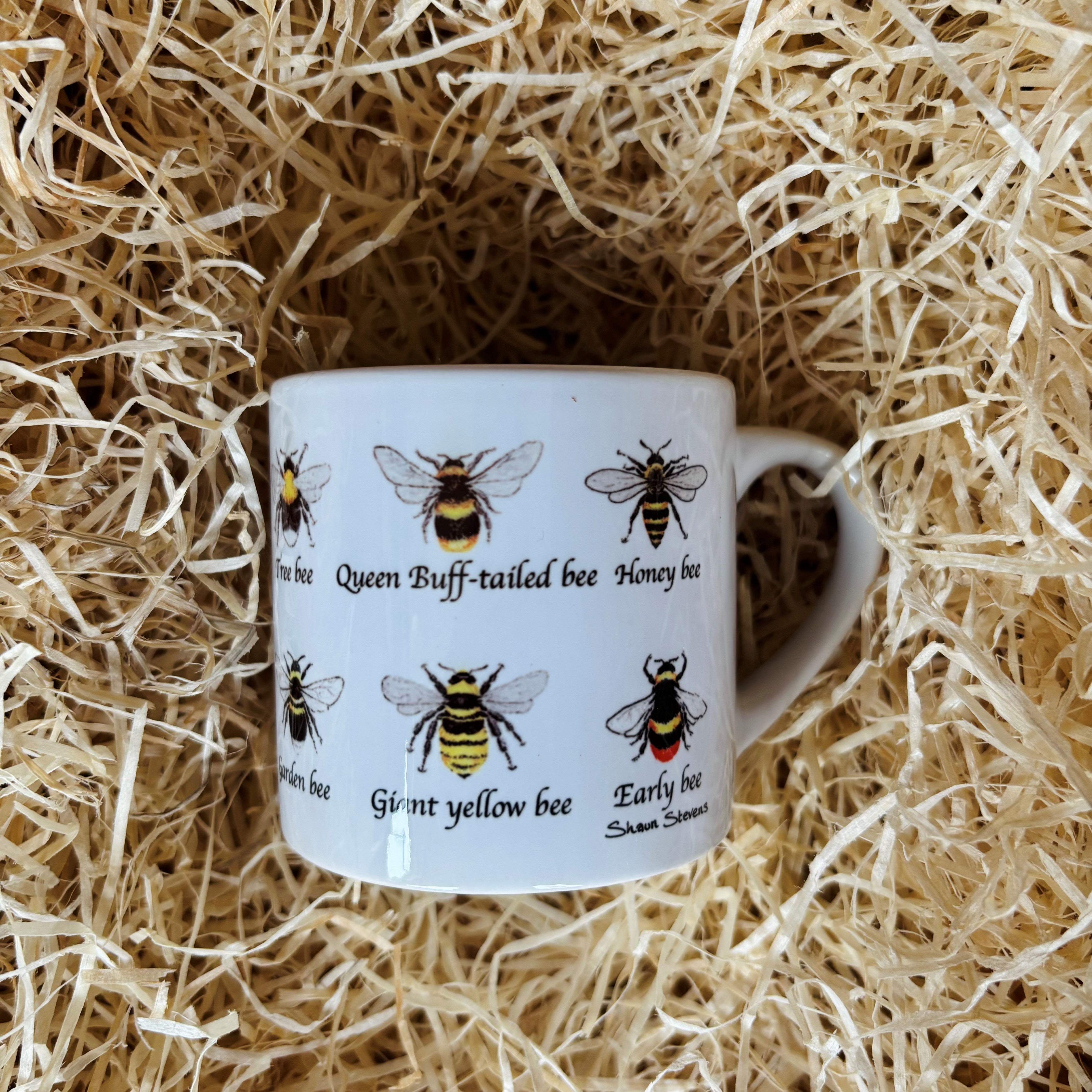 Small mug with a hand-illustrated bumblebee design by local artist Shaun Stevens