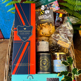 The Hattingley Christmas Luxury Hamper packed in its extra-large antique willow basket, with Hattingley Classic Reserve English sparkling wine, Noble Bee candle and honey, Summerdown peppermint crisps and New Forest treats