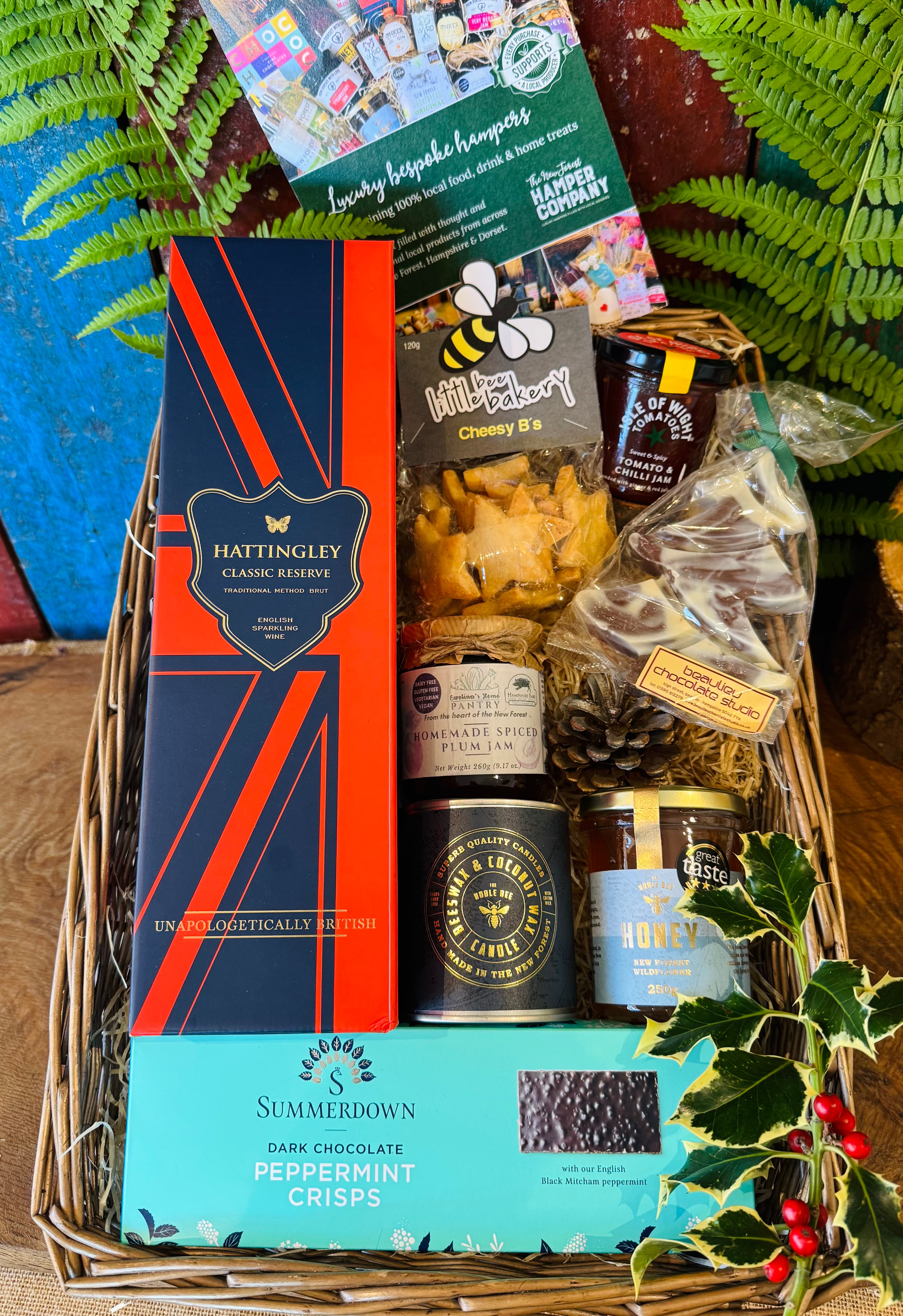 The Hattingley Christmas Luxury Hamper packed in its extra-large antique willow basket, with Hattingley Classic Reserve English sparkling wine, Noble Bee candle and honey, Summerdown peppermint crisps and New Forest treats