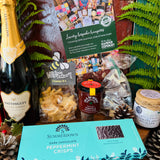 Contents of The Hattingley Christmas Luxury Hamper - Hattingley Classic Reserve, Little Bee cheesy stars, Isle of Wight tomato and chilli jam, Beaulieu white and milk chocolate Christmas tree, Ewelina's homemade spiced plum jam and Summerdown dark chocolate peppermint crisps