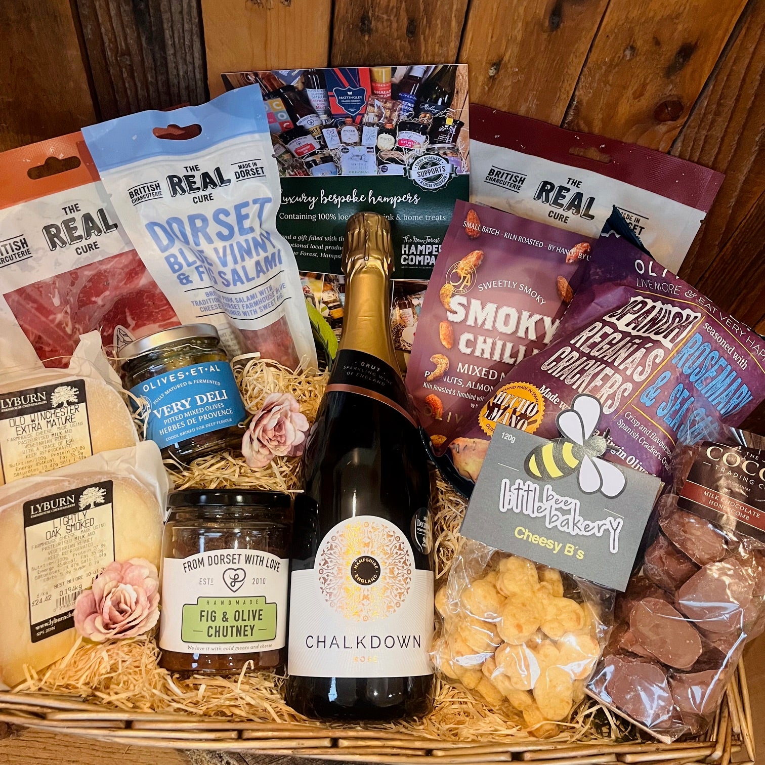 Luxury evening hamper with English sparkling rosé, artisan cheese, charcuterie, olives, crackers, chutney, savoury snacks and chocolate