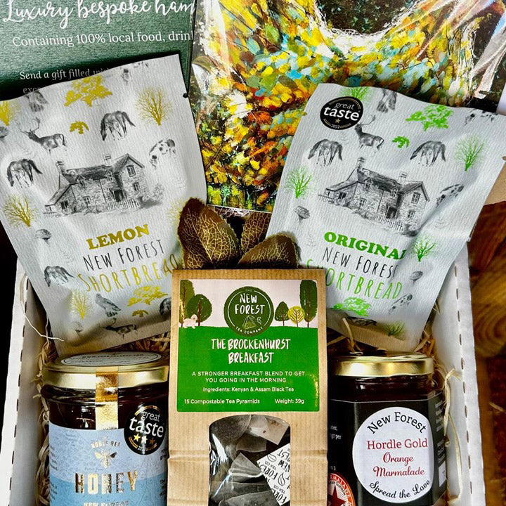 Gift basket with New Forest products including shortbread, tea, and honey.
