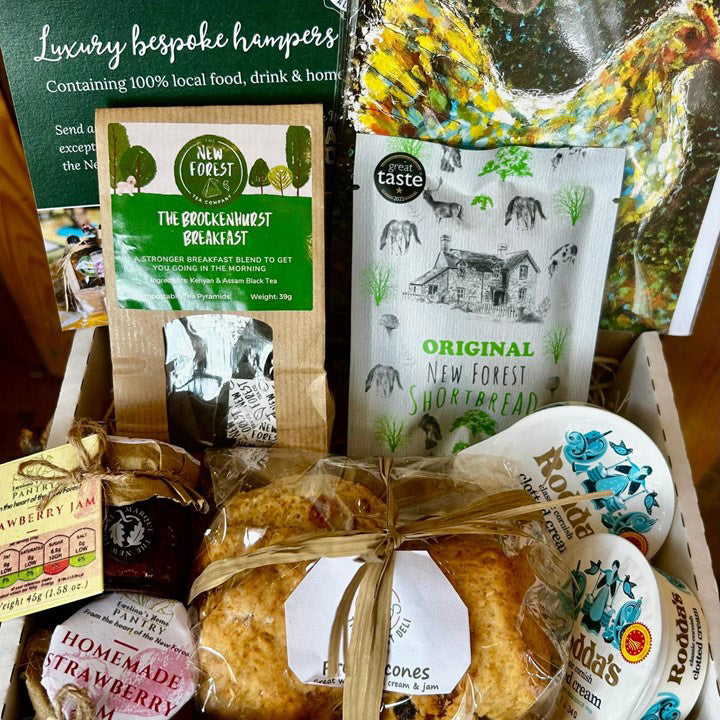 Collection of New Forest food products including tea, shortbread, and cookies with branded packaging.