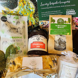 Collection of New Forest food products including jam, shortbread, and scones with branded packaging.